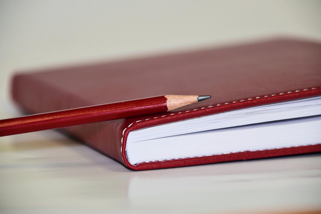 Red Notebook with Pencil